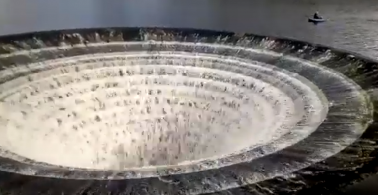 Navegado al borde del abismo: graban a dos pescadores junto a un desagüe gigante