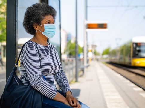 Woman with face mask travelling in berlin tram during Covid-19 outbreak
