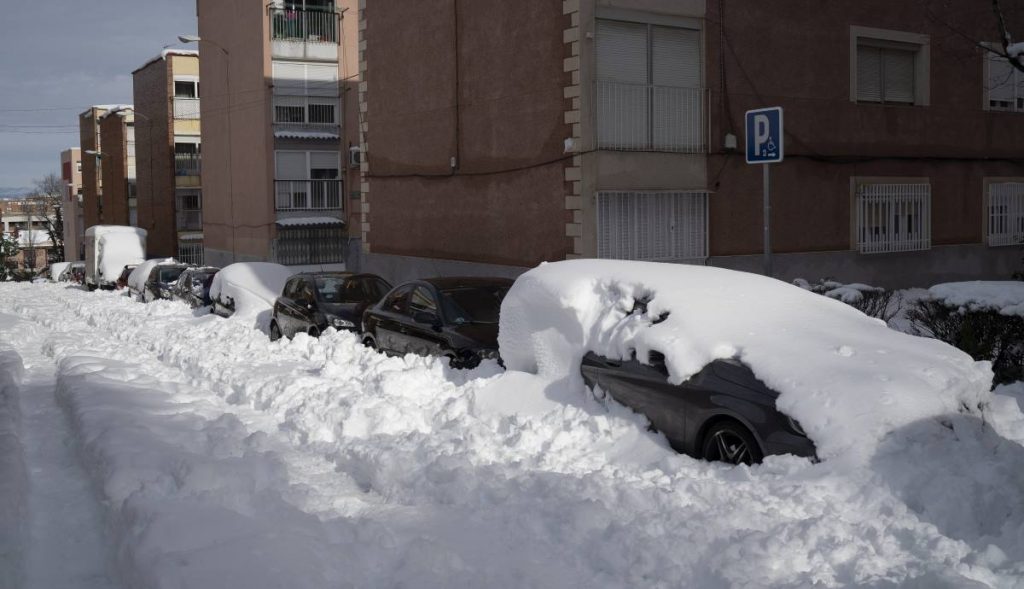 Un coche enterrado por la nieve y el hielo