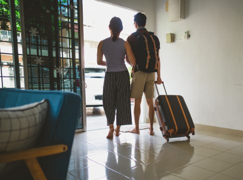 Young Asian Couple Standing By Front Door With Suitcase About To Leave For Vacation Seguridad Verano 2022