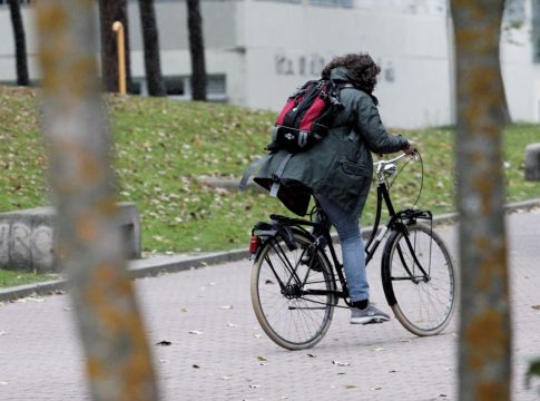 Una mujer monta en bici durante el peor temporal del otoño del 2019 en España en el que se verán afectadas 37 provincias avisadas por viento, nieve, oleaje o lluvia, en Madrid a 14 de noviembre de 2019.