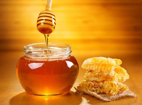 jar of honey with honeycomb