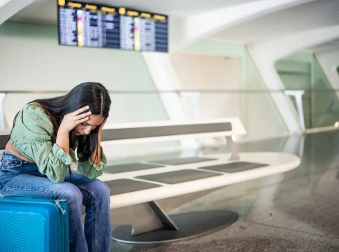 sad-latin-girl-airport-because-her-flight-has-been-canceled-copy-space