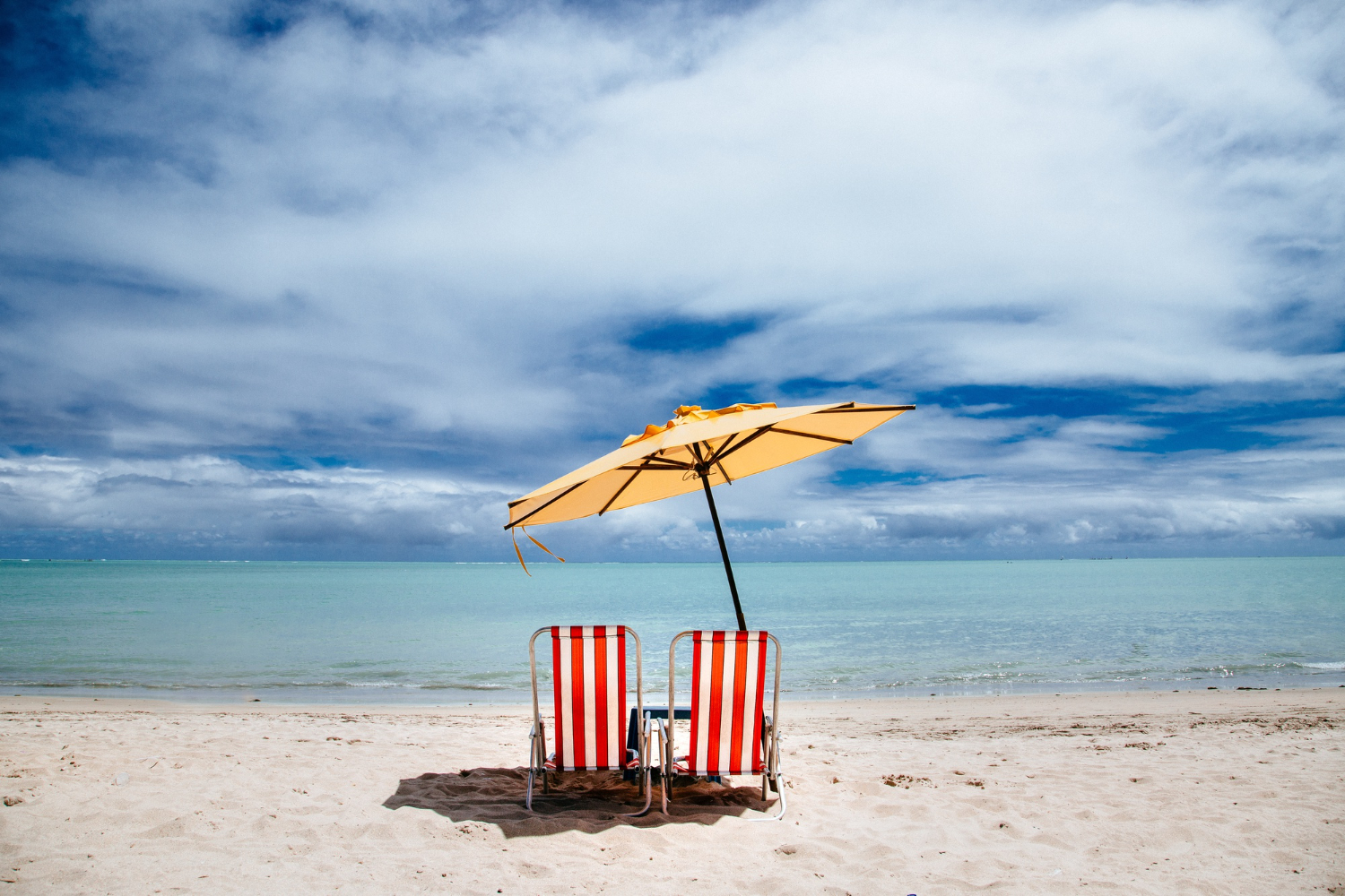 playa arena sombrilla Freepik
